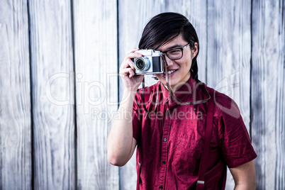 Hipster taking pictures with an old camera