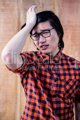 Sad hipster holding his head with his hand Sad hipster holding his head with his hand