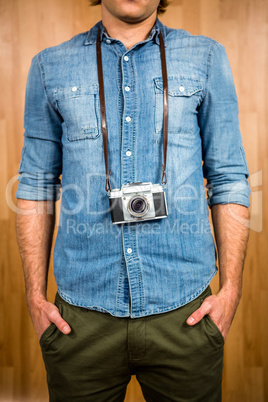 Hipster man holding digital camera