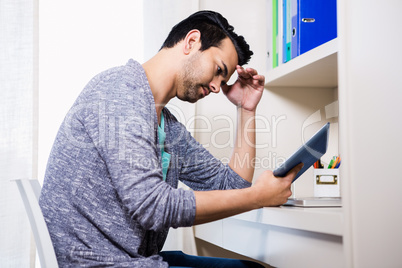 Focused man using tablet