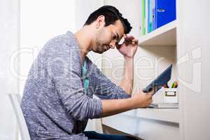Focused man using tablet