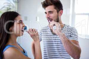 Couple brushing their teeth