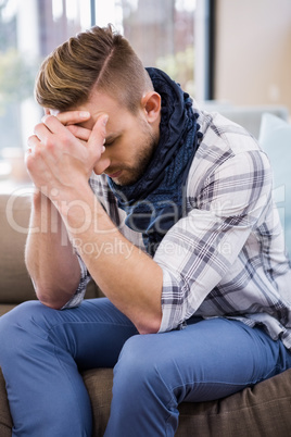 Worried man thinking on the couch