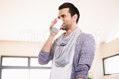 Handsome man drinking hot beverage