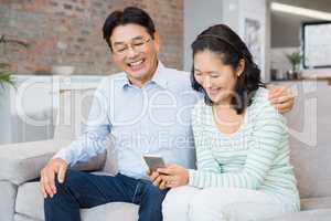 Happy couple using smartphone