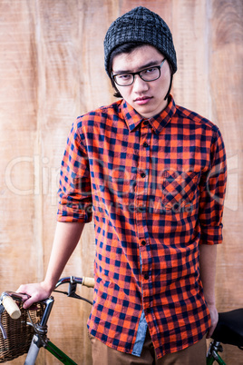 Serious hipster holding a bike