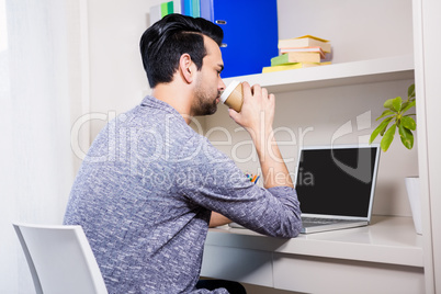 Focused man using laptop