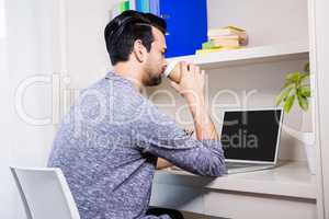 Focused man using laptop