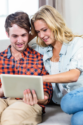 Smiling couple using tablet computer