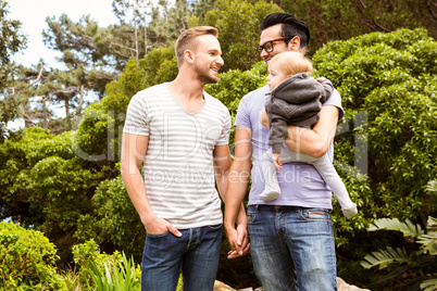 Smiling gay couple with child