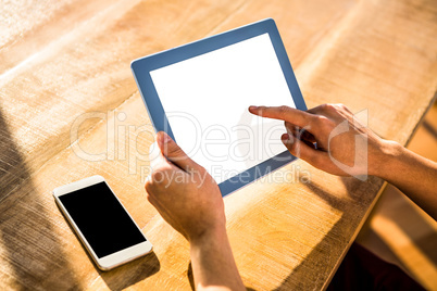 Over shoulder view of casual man using tablet