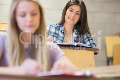 Students sitting beside each other while learning