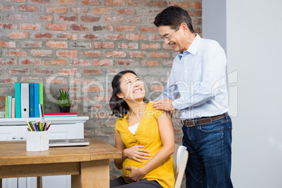 Happy couple talking at home