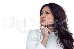 Thoughtful Asian woman with finger on chin
