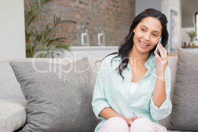 Smiling brunette on a phone call