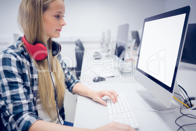 Serious student working on computer