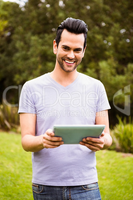 Smiling man using tablet