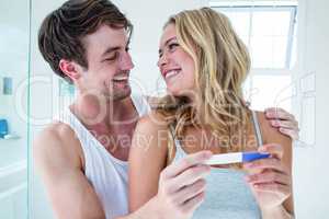 Happy couple looking at pregnancy test