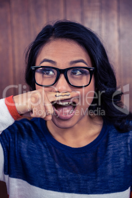 Asian woman with mustache on finger