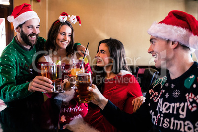 Festive friends drinking beer and cocktail