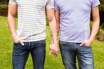 Mid section of gay couple with hand in hand