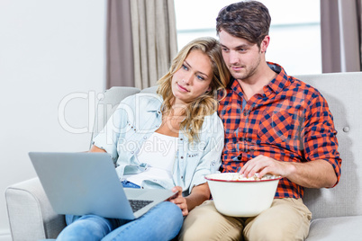Couple watching a movie on laptop