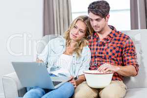 Couple watching a movie on laptop