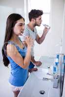 Couple brushing their teeth