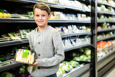 Cute boy holding asparagus