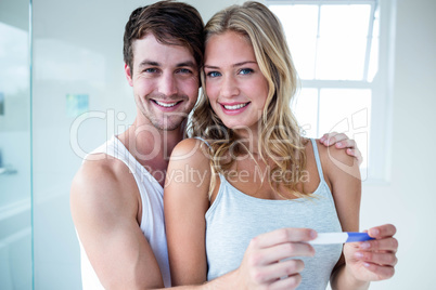 Happy couple looking at pregnancy test