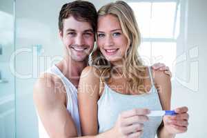 Happy couple looking at pregnancy test