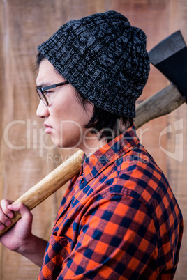 Side view of hipster holding a axe