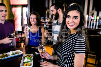 Portrait of woman having an aperitif with friends