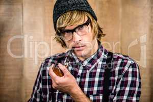 Serious blond hipster smoking a pipe