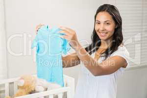 Smiling brunette holding baby tshirt