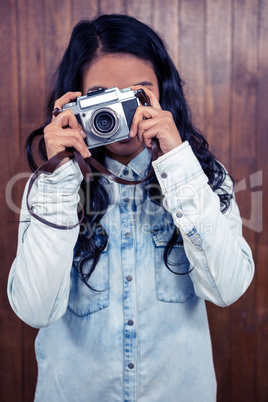 Asian woman taking picture with digital camera