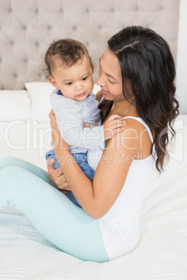 Happy brunette holding her baby