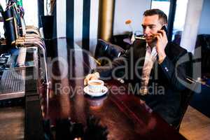 Businessman on the phone having a coffee