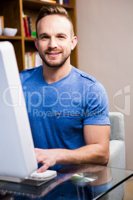 Smiling man using computer