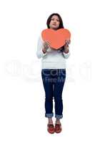 Asian woman holding paper heart