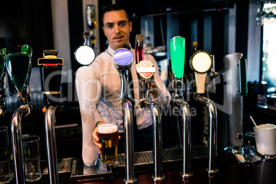 Barman serving a pint of beer