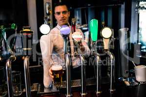 Barman serving a pint of beer