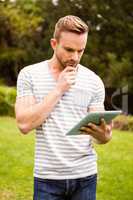 Thoughtful man using tablet