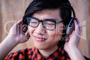 Smiling hipster listening music with headphone