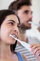 Couple brushing their teeth