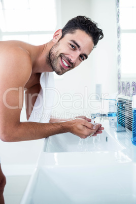 Man washing his face in sink