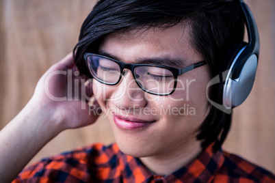 Smiling hipster listening music with headphone