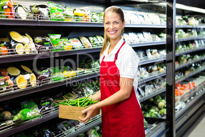 Female worker carrying vegetables box