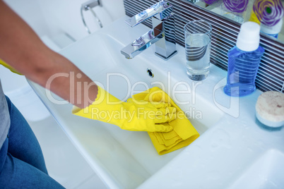 Woman cleaning the sink