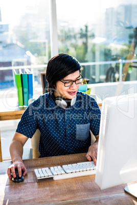 Smiling asian businessman using computer